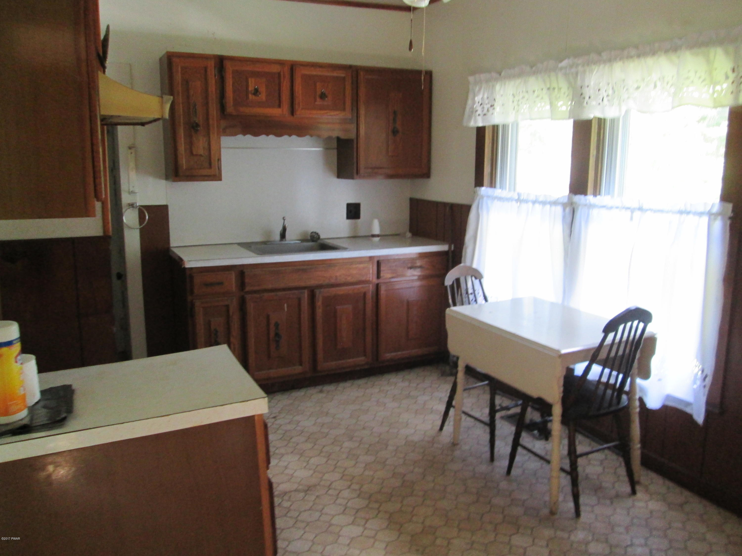 86 Beaver Hollow Road Lakewood, PA 18439 - Photo 6 of 30 a kitchen with a table chairs and a refrigerator