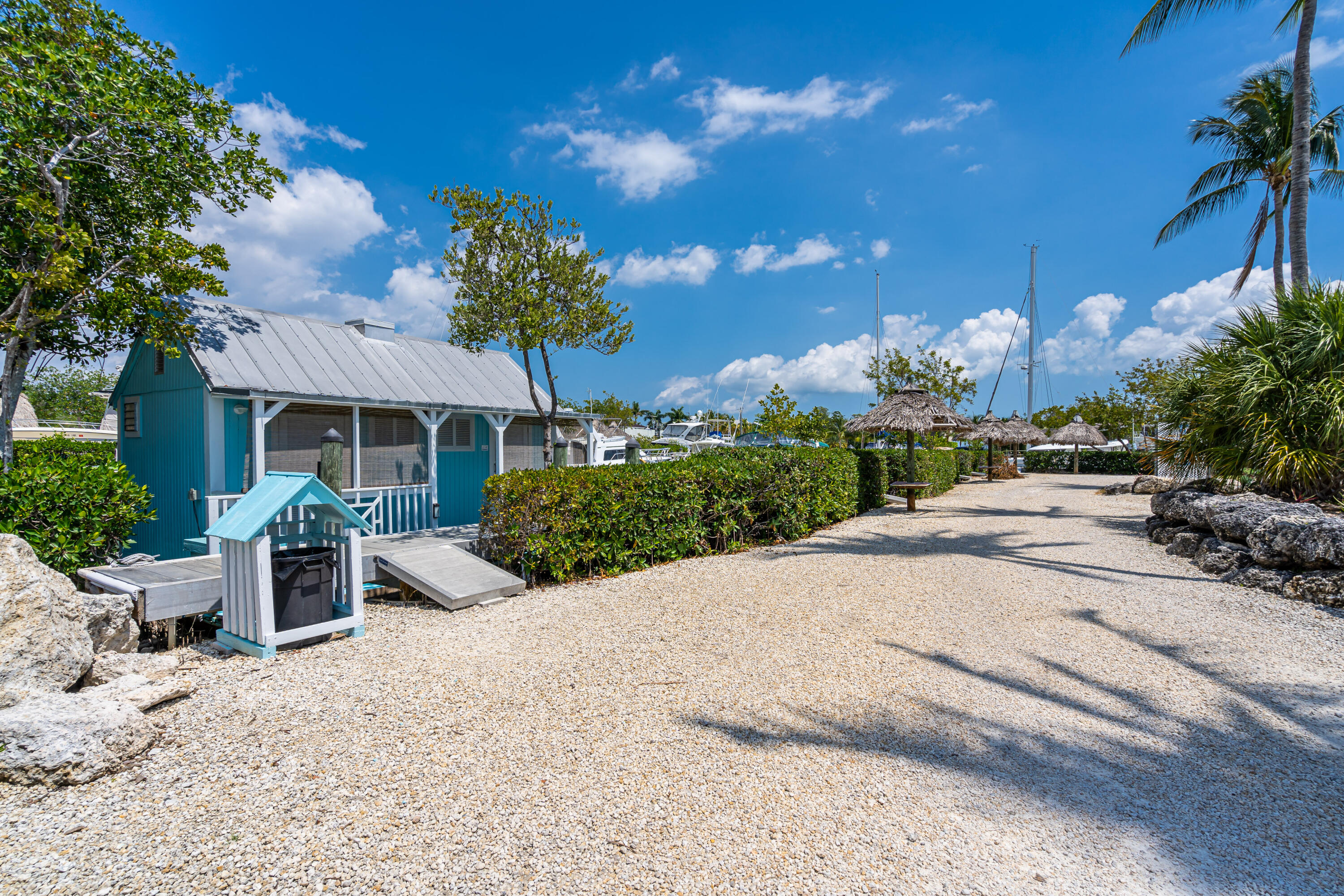 100 Morris Lane, Unit E8 Key Largo, FL 33037 - Photo 11 of 22 a front view of a house with a yard and potted plants