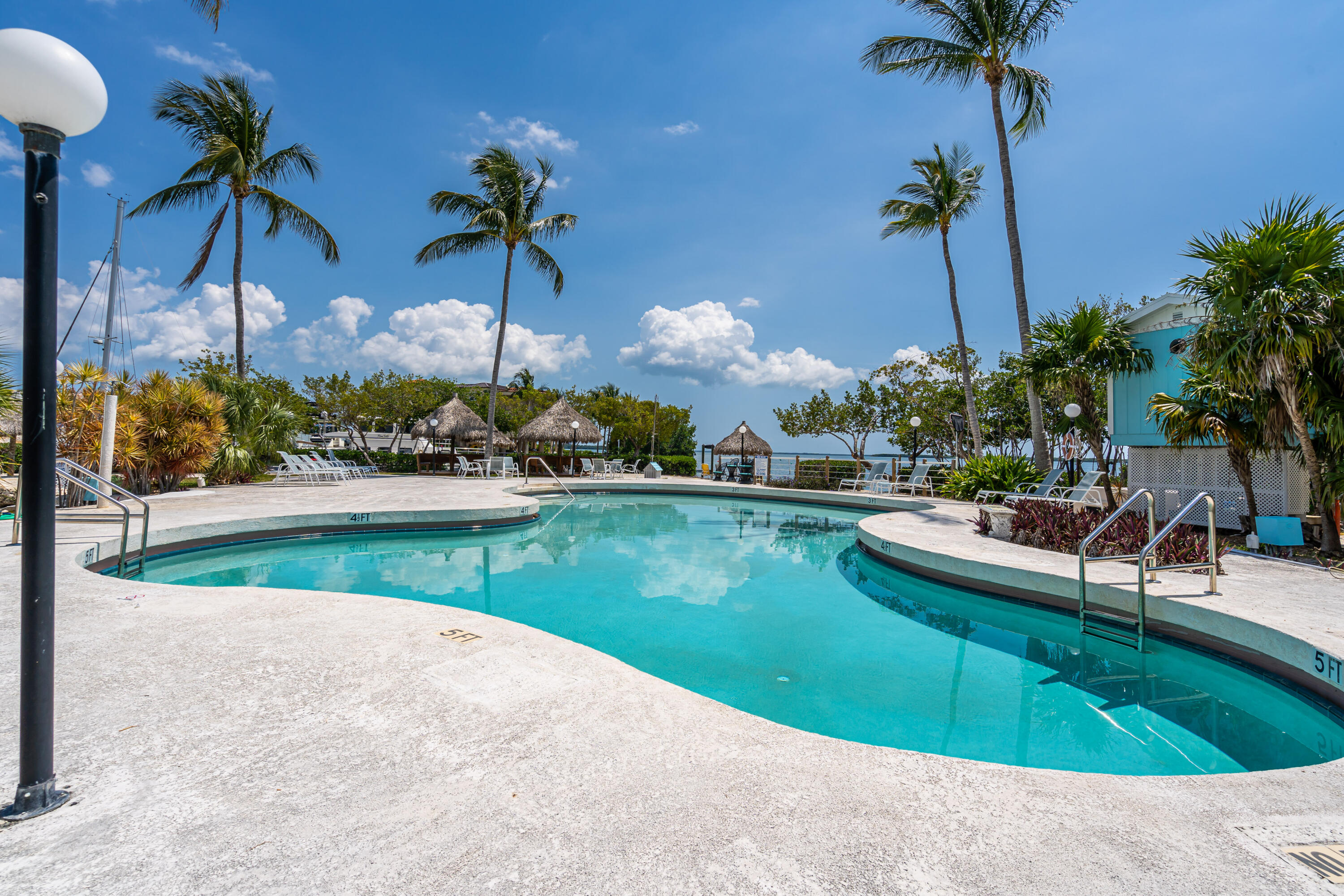 100 Morris Lane, Unit E8 Key Largo, FL 33037 - Photo 13 of 22 a view of a swimming pool with a table and chairs