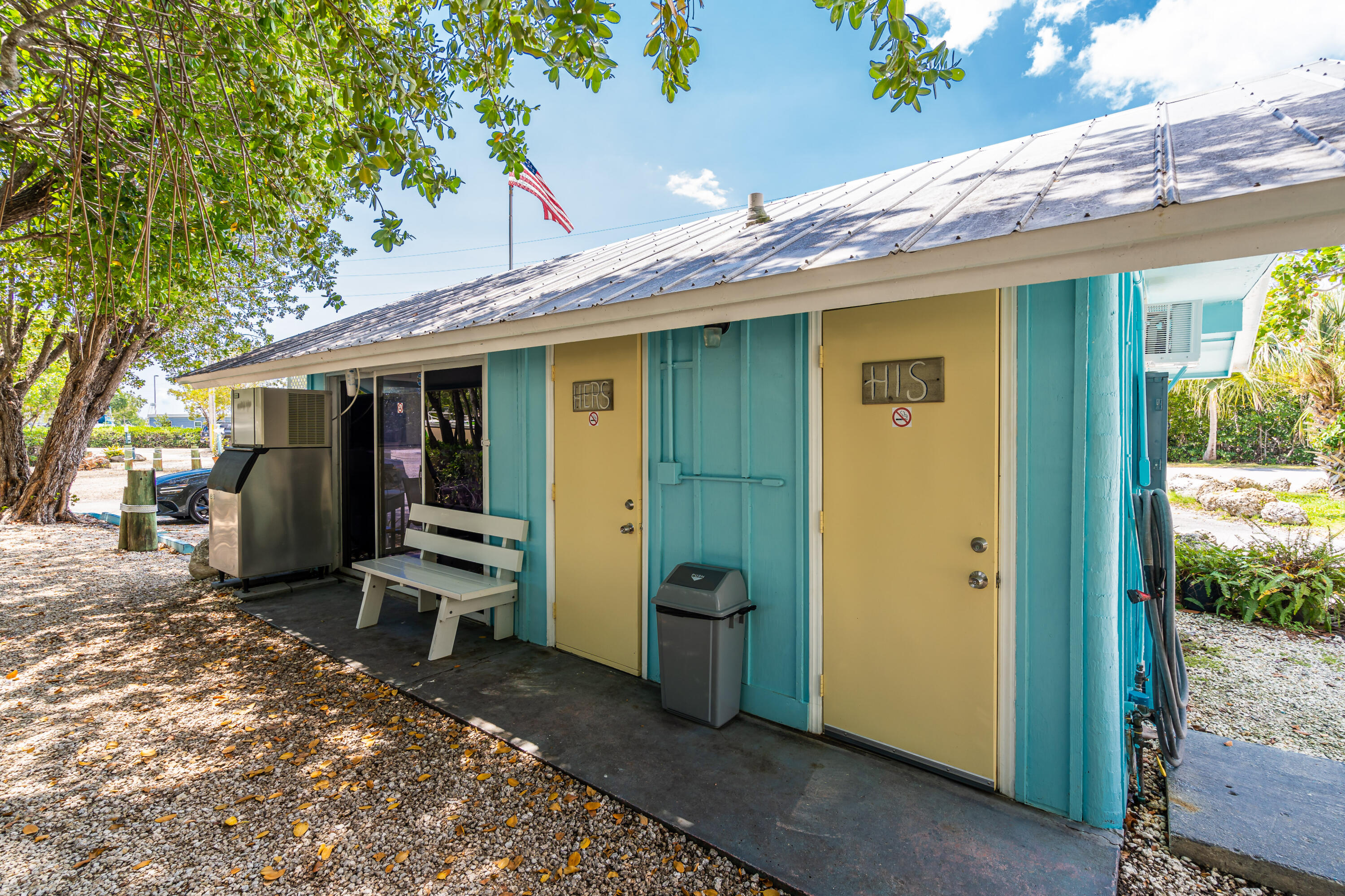 100 Morris Lane, Unit E8 Key Largo, FL 33037 - Photo 9 of 22 a view of a patio with table and chairs near a large tree