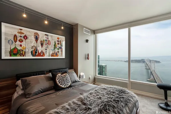 a bedroom with a large bed and a window
