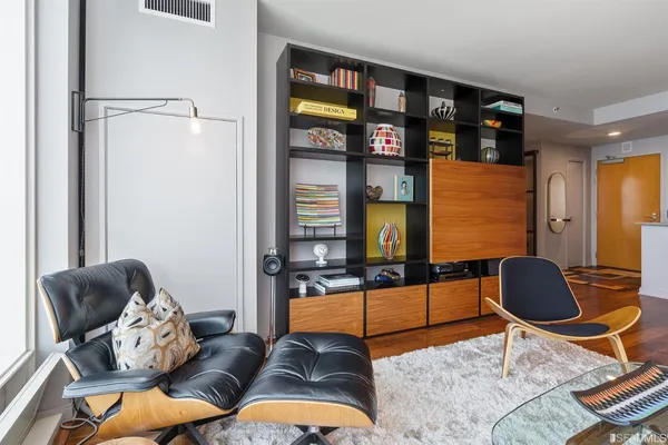 a living room with furniture a rug and a window