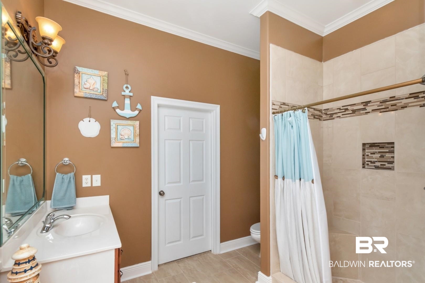 9905 Carnoustie Court Foley, AL 36535 - Photo 14 of 31 Bathroom featuring vanity, a tile shower, and crown molding