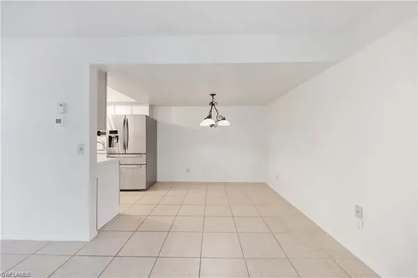 a kitchen with stainless steel appliances a refrigerator sink and cabinets
