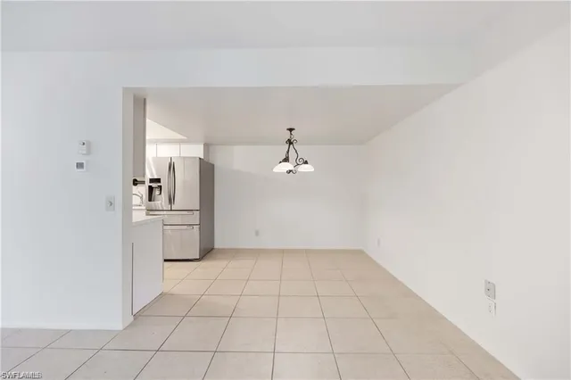 a kitchen with stainless steel appliances a refrigerator sink and cabinets