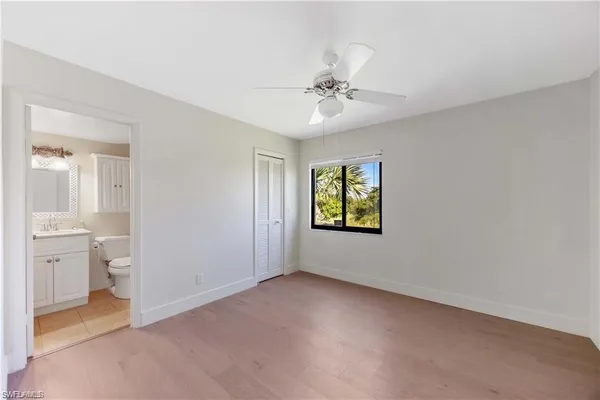 a bathroom with a sink toilet vanity and tub
