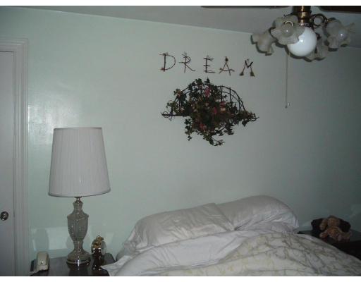 56 Bessemer Street Springfield, MA 01104 - Photo 10 of 15 a bed room with a bed and a lamp