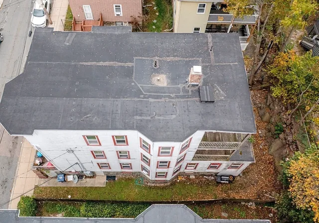 an aerial view of a house with garden space and sitting space