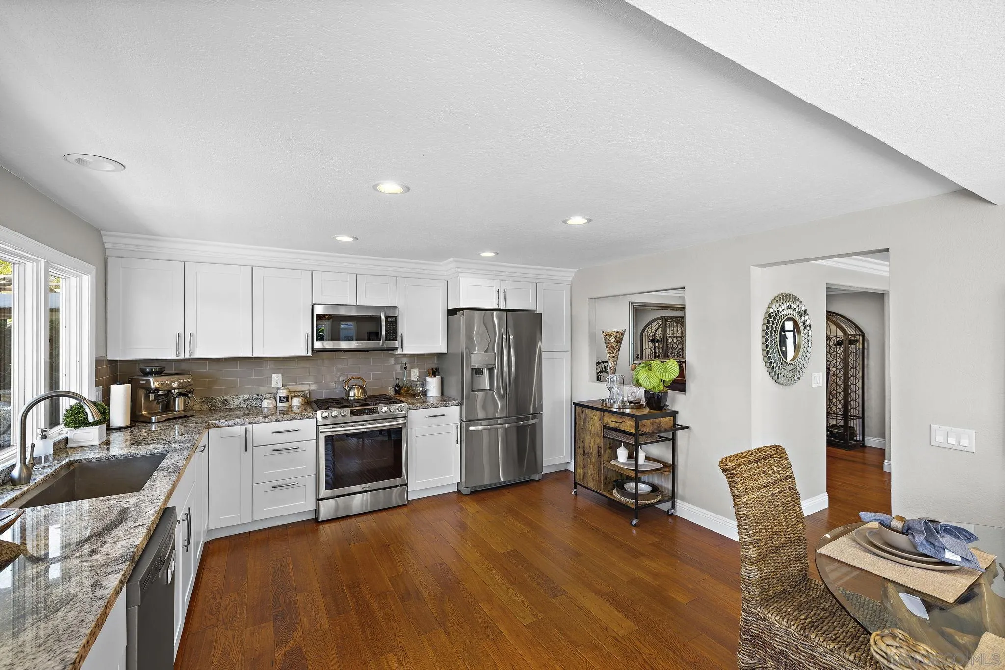 22875 Ridge Rte Lane Lake Forest, CA 92630 - Photo 12 of 54 a kitchen with stainless steel appliances granite countertop a refrigerator oven stove top oven a sink dishwasher and chairs with wooden floor