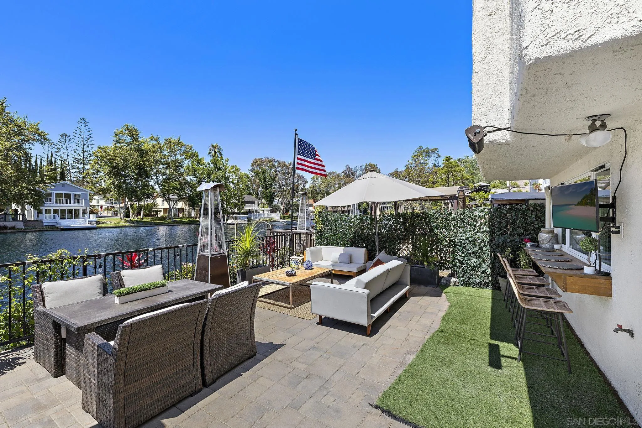 22875 Ridge Rte Lane Lake Forest, CA 92630 - Photo 32 of 54 a view of a patio with couches table and chairs under an umbrella with a fire pit