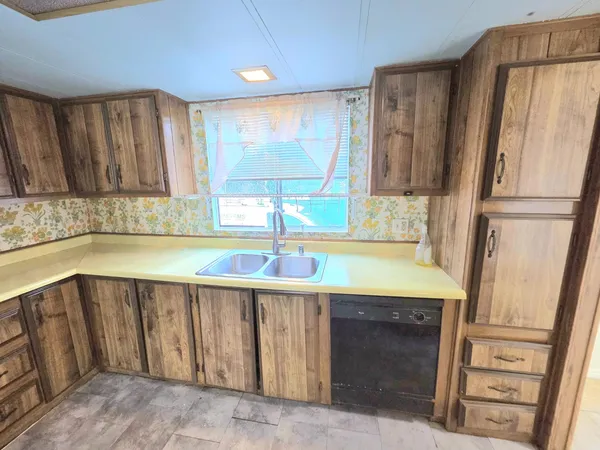 a kitchen with a stove a sink and a refrigerator