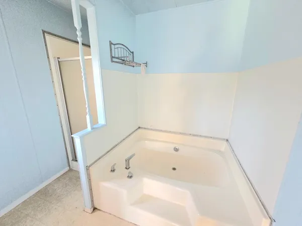 a bathroom with a window and tub