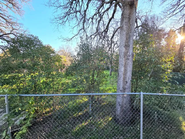 a backyard of a house with barbeque oven table and chairs
