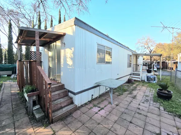 a view of a backyard with sitting area