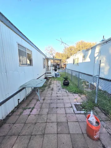 a view of a backyard with sitting area