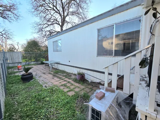 a backyard of a house with barbeque oven fire pit and outdoor seating