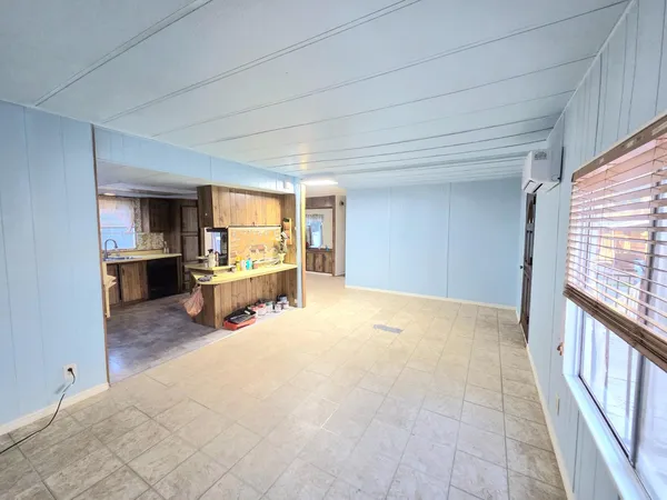 a kitchen with stainless steel appliances granite countertop a refrigerator a stove and a sink with cabinets