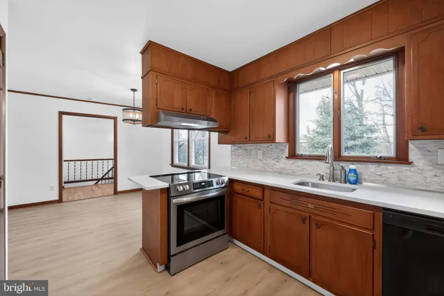 a kitchen with stainless steel appliances granite countertop a refrigerator stove and microwave