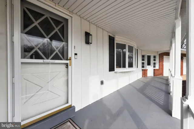a view of a hallway and a livingroom with wooden floor