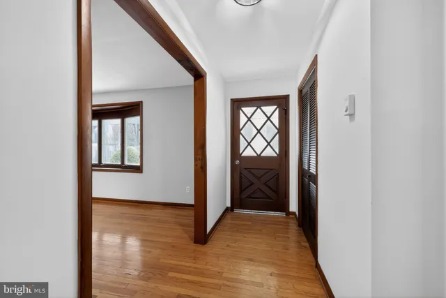 a view of empty room with wooden floor and fireplace