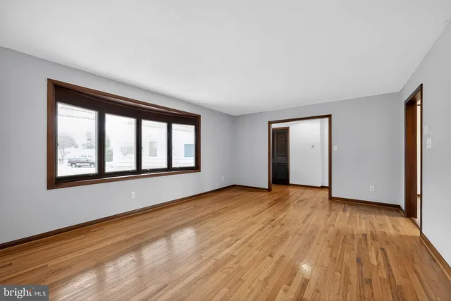 a kitchen with stainless steel appliances granite countertop a stove a sink dishwasher a refrigerator and a wooden floor