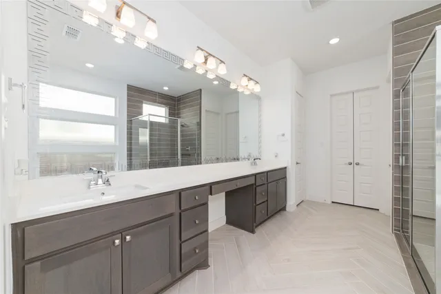 a spacious bathroom with a double vanity sink mirror and double