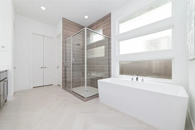 a bathroom with a bathtub a sink and a shower