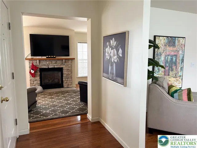 a living room with furniture a flat screen tv and a fireplace