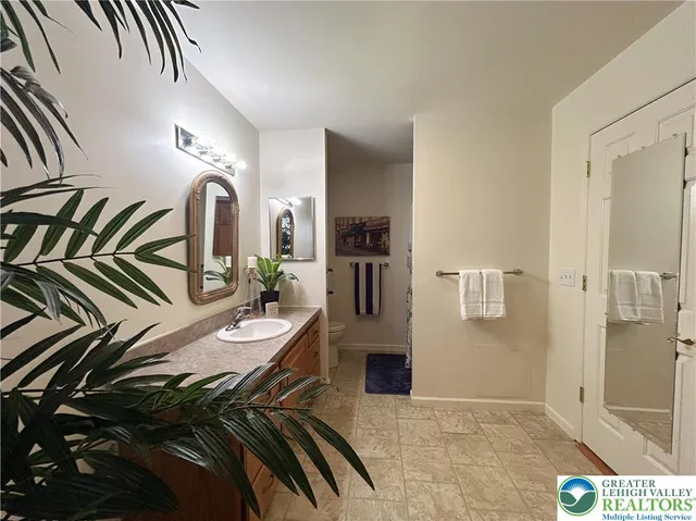 a bed room with a bed and a view of bathroom