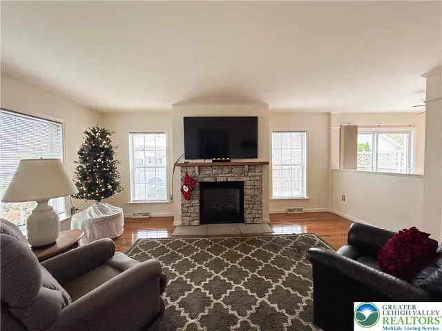 a living room with furniture and a fireplace