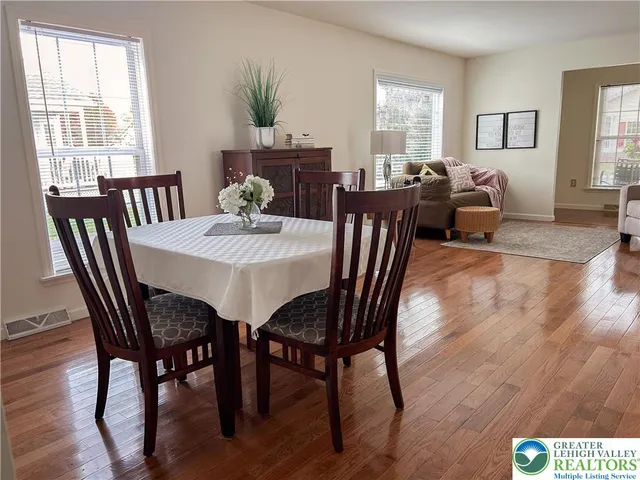 a view of a dining room with furniture window and wooden floor
