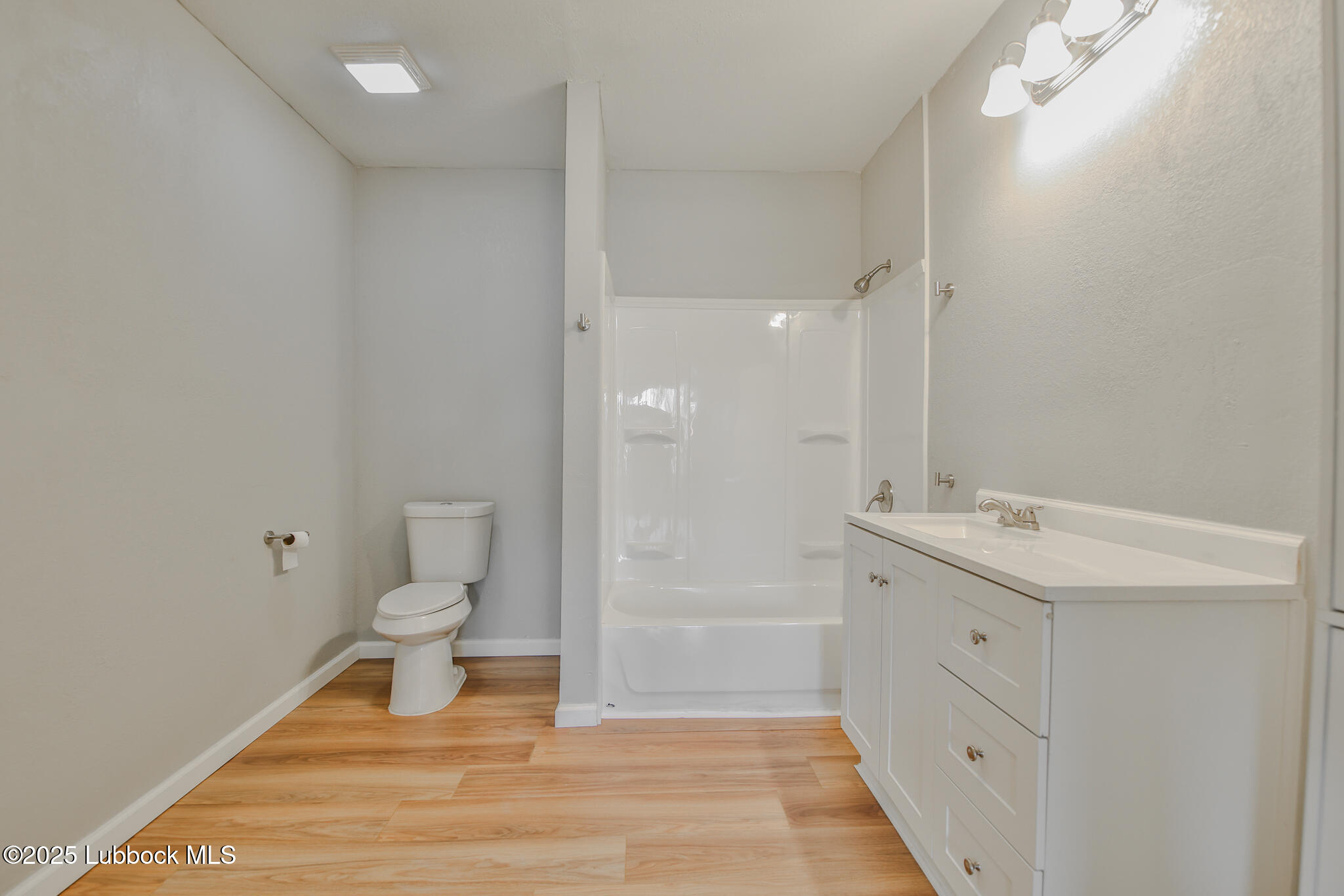 115 Yonkers Street Plainview, TX 79072 - Photo 18 of 28 a bathroom with a sink a toilet and shower