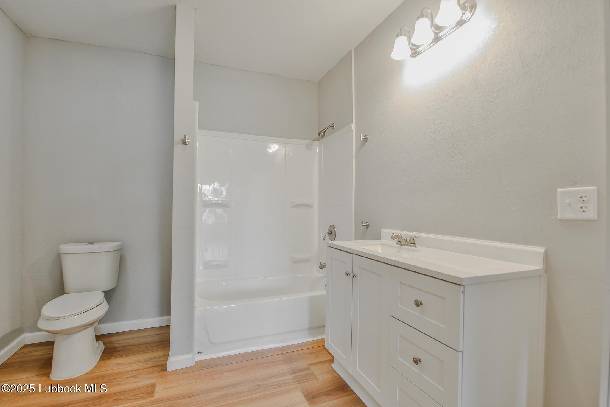 115 Yonkers Street Plainview, TX 79072 - Photo 19 of 28 a bathroom with a toilet a sink and mirror