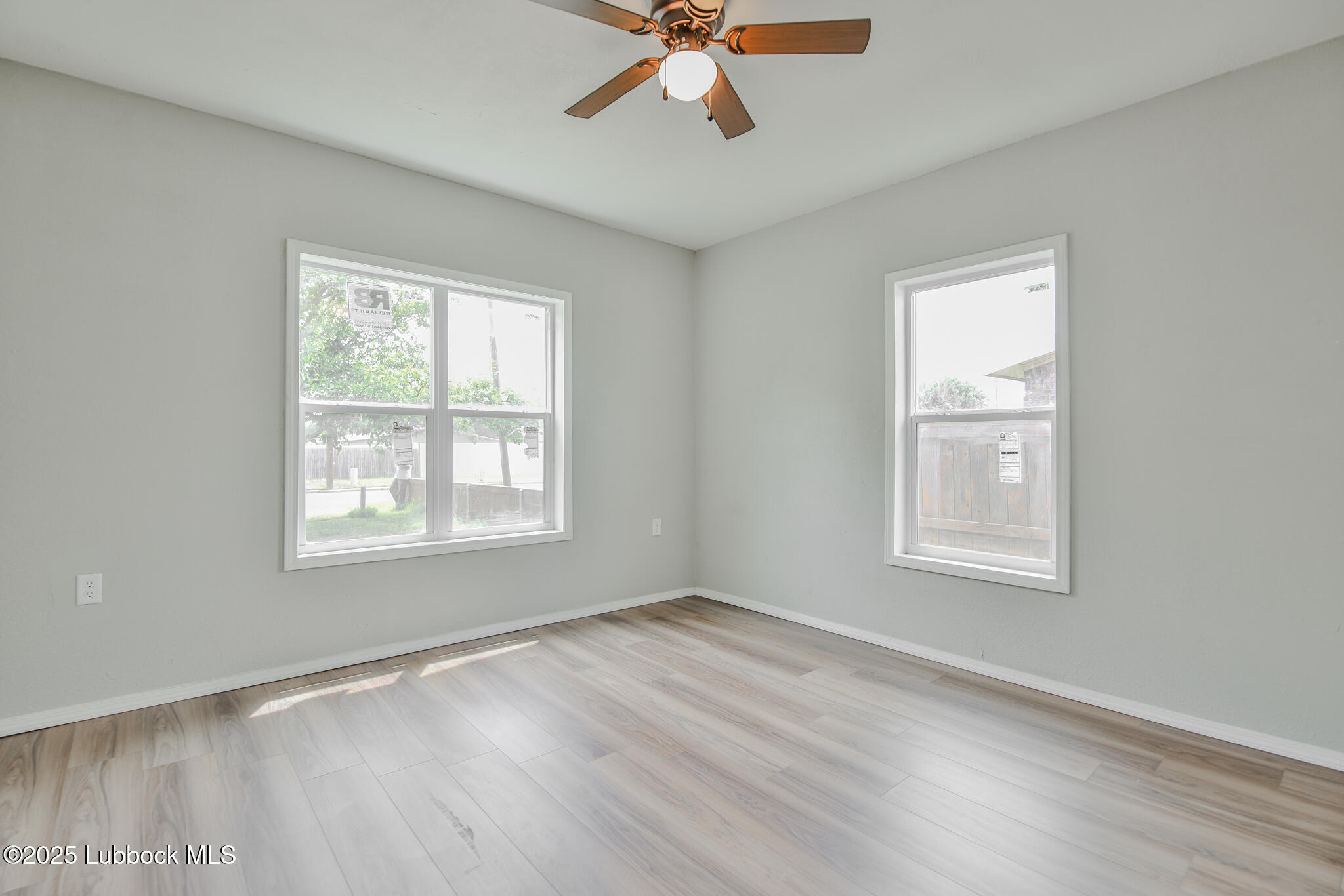 115 Yonkers Street Plainview, TX 79072 - Photo 23 of 28 a view of an empty room with wooden floor and a window
