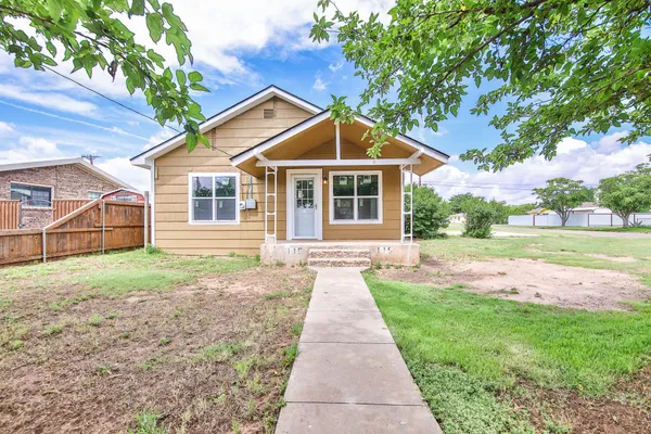 a front view of a house with yard
