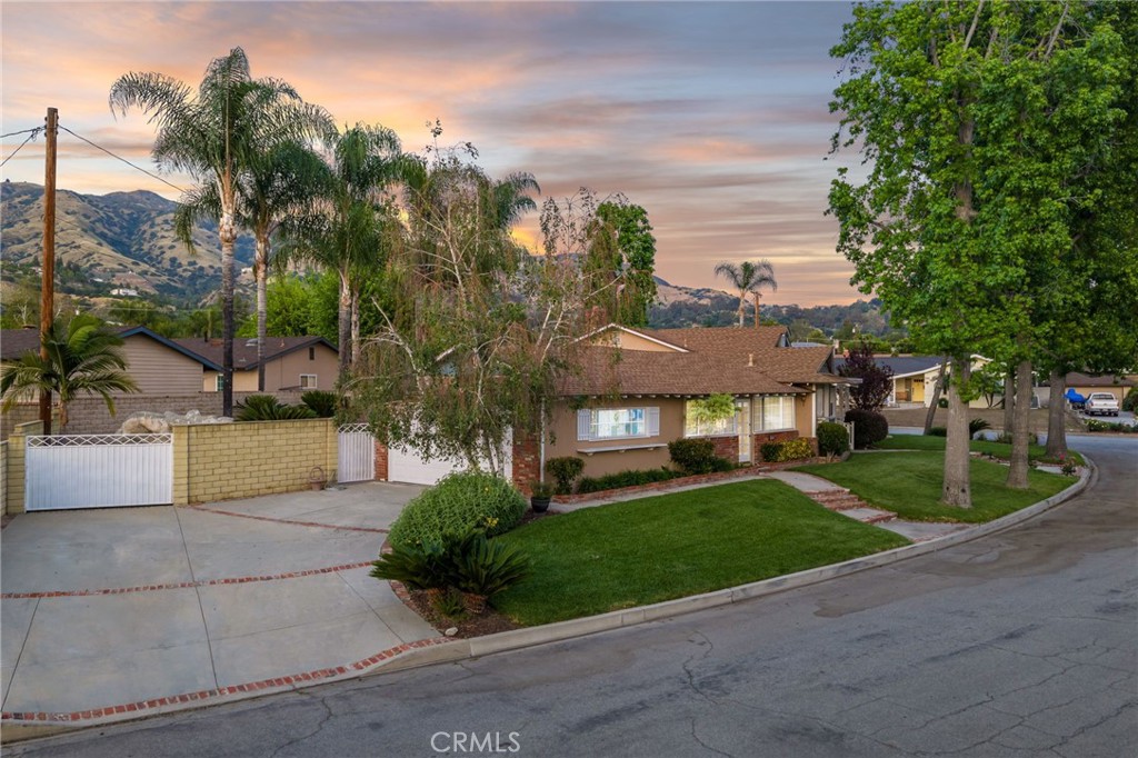 222 South Wagonwheel Road Glendora, CA 91741 - Photo 11 of 70 a front view of a house with a yard and trees