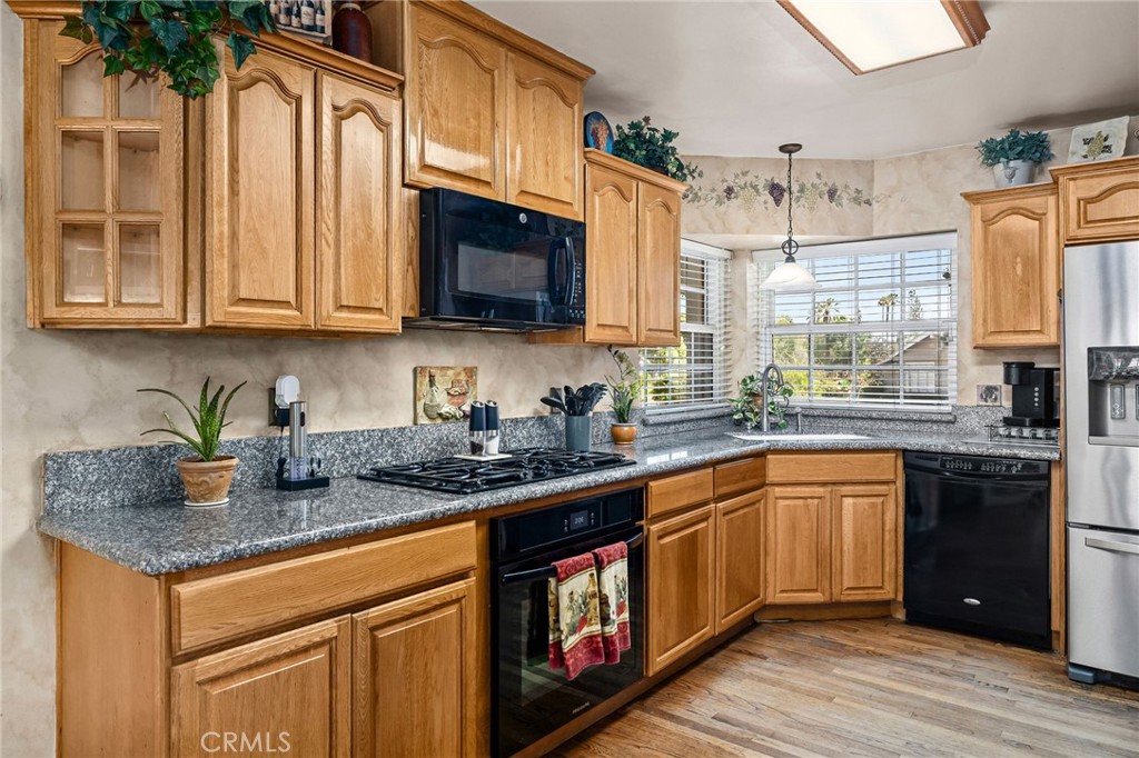 222 South Wagonwheel Road Glendora, CA 91741 - Photo 25 of 70 a kitchen with stainless steel appliances granite countertop a sink stove and cabinets