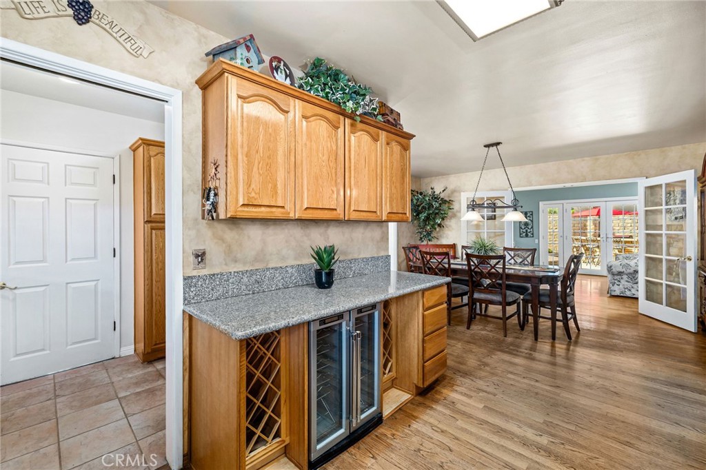 222 South Wagonwheel Road Glendora, CA 91741 - Photo 28 of 70 a kitchen with stainless steel appliances granite countertop a stove top oven a sink a dining table and chairs with wooden floor
