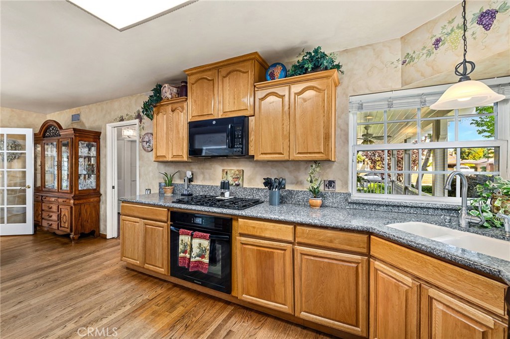 222 South Wagonwheel Road Glendora, CA 91741 - Photo 31 of 70 a kitchen with stainless steel appliances granite countertop a sink stove and cabinets