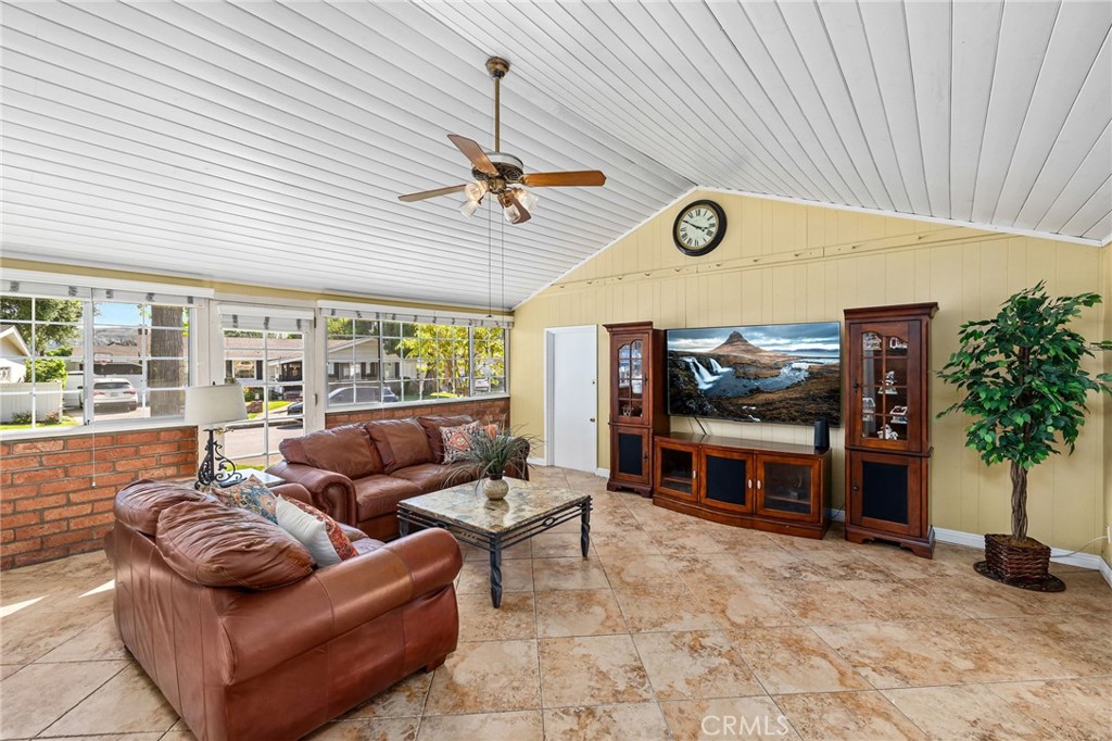222 South Wagonwheel Road Glendora, CA 91741 - Photo 33 of 70 a living room with furniture a flat screen tv and a floor to ceiling window