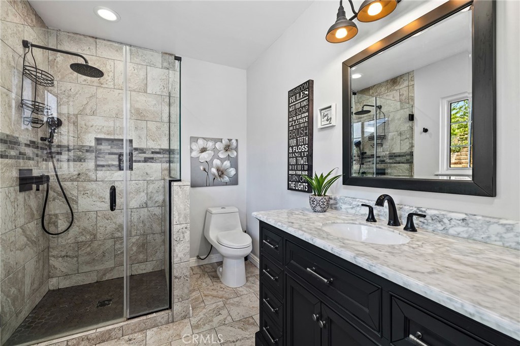 222 South Wagonwheel Road Glendora, CA 91741 - Photo 42 of 70 a bathroom with a granite countertop sink a toilet and shower