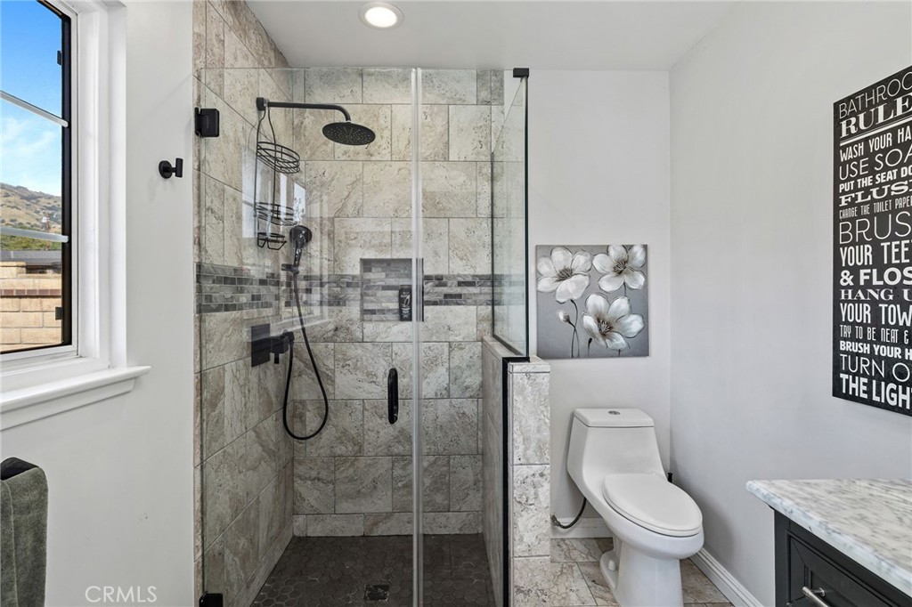 222 South Wagonwheel Road Glendora, CA 91741 - Photo 43 of 70 a bathroom with a granite countertop shower a toilet and a shower