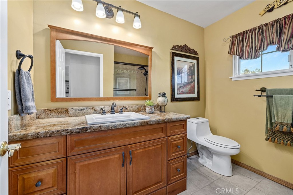 222 South Wagonwheel Road Glendora, CA 91741 - Photo 46 of 70 a bathroom with a granite countertop toilet sink and mirror