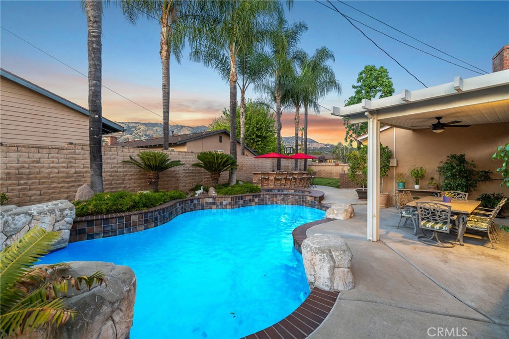 222 South Wagonwheel Road Glendora, CA 91741 - Photo 50 of 70 a view of a swimming pool with a couches chairs and potted plants