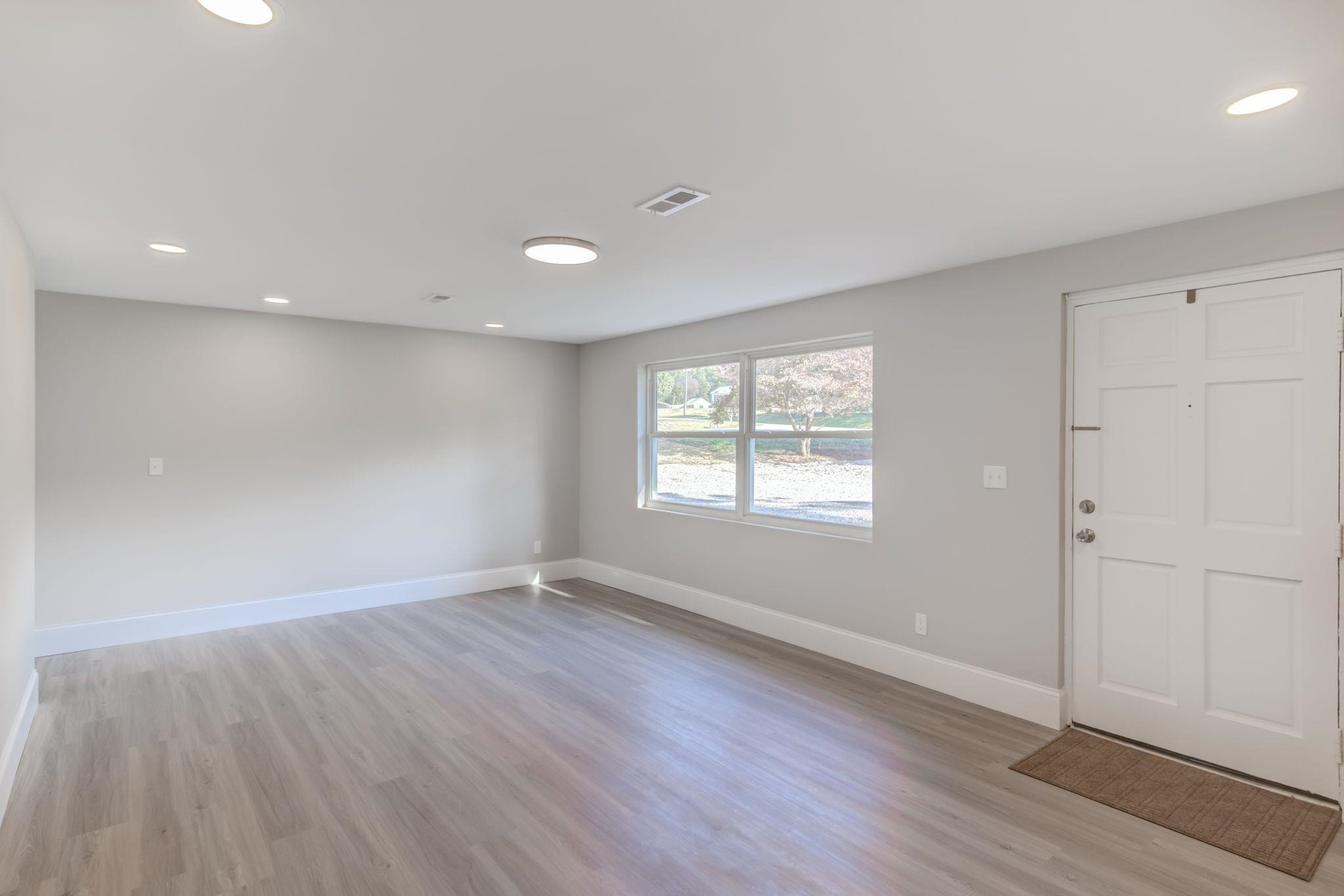 9800 Fanny Brown Road Raleigh, NC 27603 - Photo 12 of 29 Spacious family room with smooth ceilings, can lights, freshly painted interior, LVP flooring and loads of natural light! Family Room