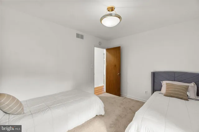 a bedroom with a bed and a lamp