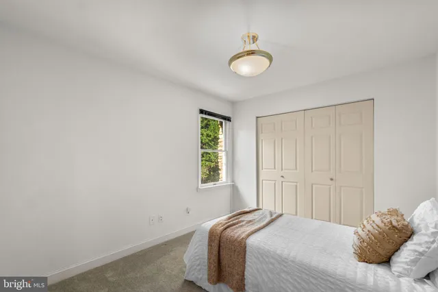 a bedroom with a bed and a lamp