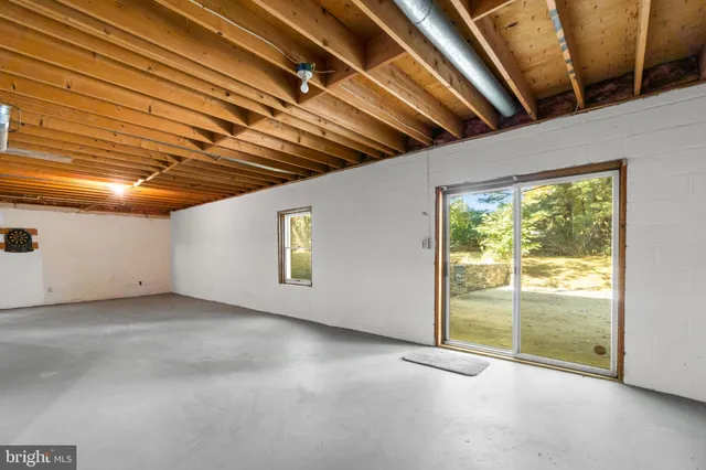 a view of empty room with wooden ceiling