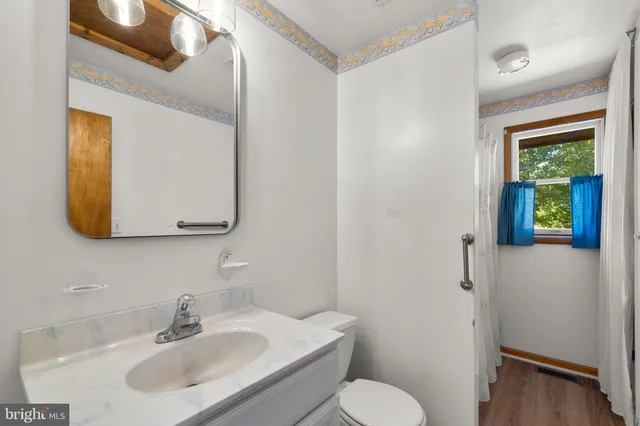 a bedroom with a bed next to a window