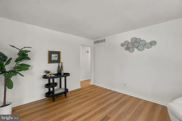 a view of a room with wooden floor and a potted plant